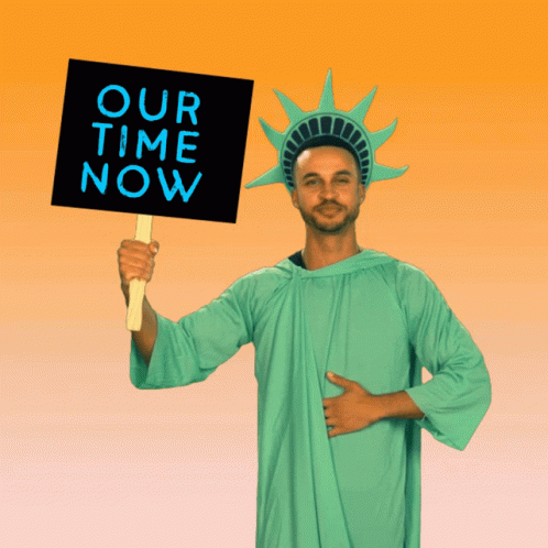 a person in a statue of liberty outfit holding a sign