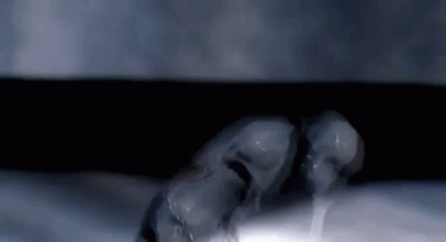 two skulls in the dark with water dripping from their heads