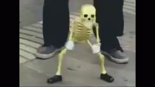 a person standing next to a skeleton wearing sneakers