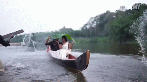 two men are riding in a boat on the river