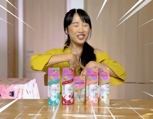 an asian girl with seven packages of handmade hand soap