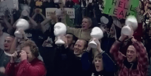 people holding white masks in the air