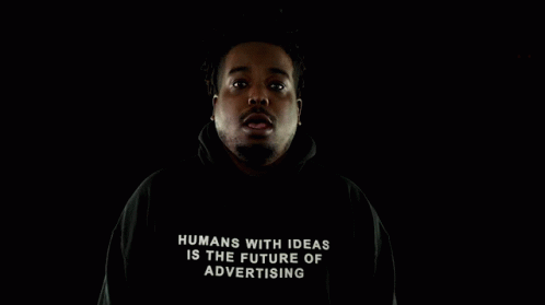 a man wearing a hooded jacket with a lit up message on it