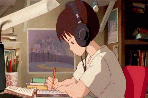 a boy is writing in a notepad and wearing headphones