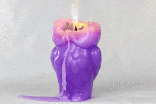 there is a pink and purple candle on white background