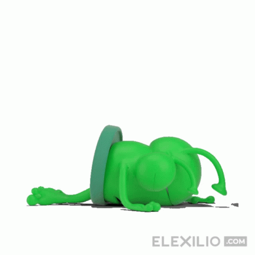 a green animal sitting on top of a white wall