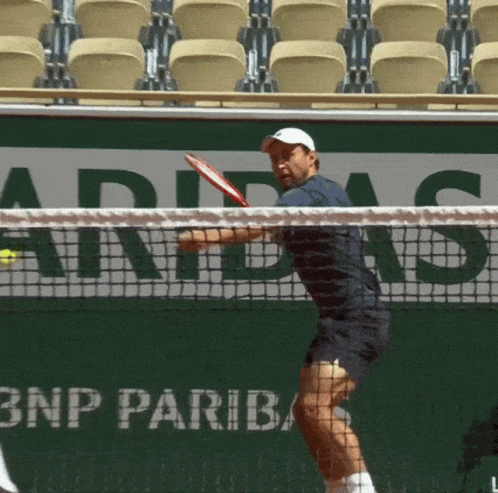 a tennis player with blue skin, swinging his racquet