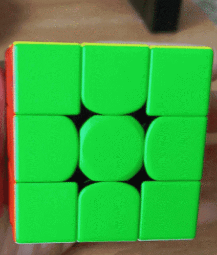 someone holding a toy with square pieces on top