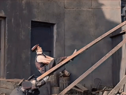 a man with a hat is working on some stairs