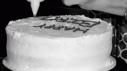 a person blowing out the candles on a birthday cake