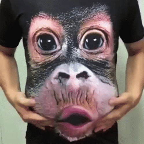 a person with very large eyes and no nose is holding a t - shirt