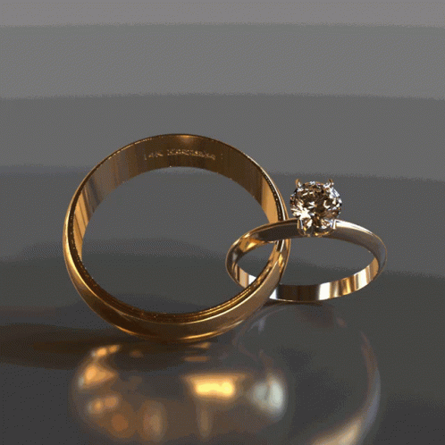 two engagement rings sitting side by side on the ground