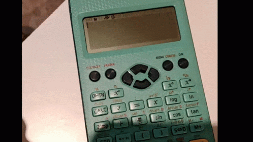 a green calculator is sitting on top of a table