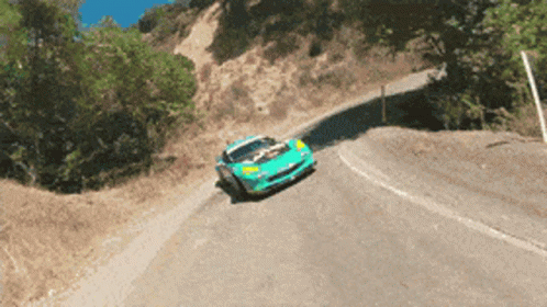 there is a yellow vehicle that is going down a mountain road
