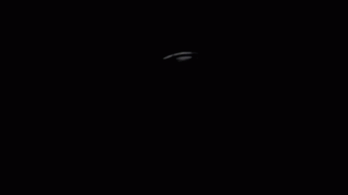 an airplane flying through the dark night sky