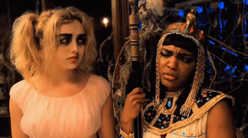 a girl dressed as a pharaoh and another woman with fake hair
