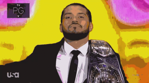 a man in a suit and tie holding a large white wrestler belt