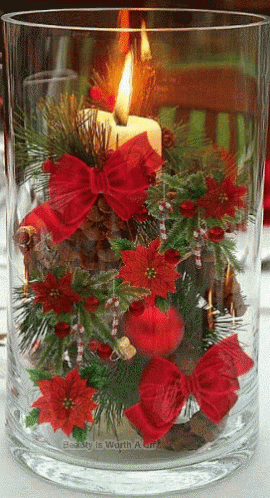 a large clear vase with flowers inside on a table
