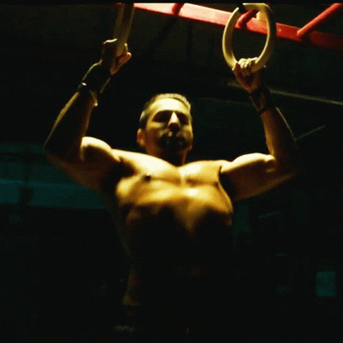 a shirtless man with the ring in his hands