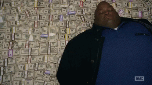 a man laying on the ground, covered in money