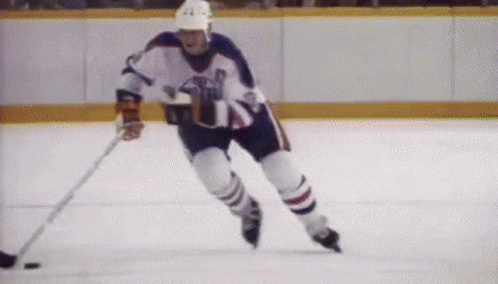 an image of a hockey player going for the puck