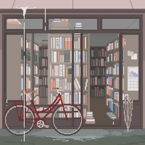 a bicycle parked in front of a liry full of books