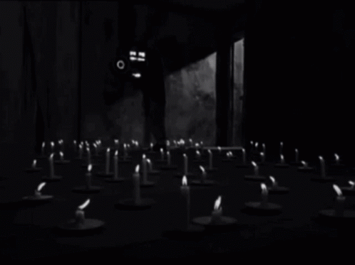 some small candles sit on a table in a black and white po