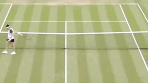the man in white is playing tennis on a court