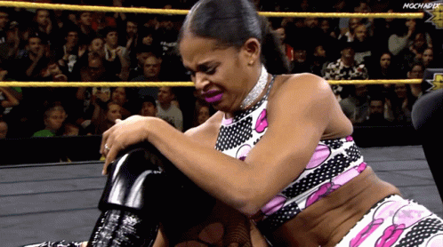 a woman in the middle of a wrestling ring