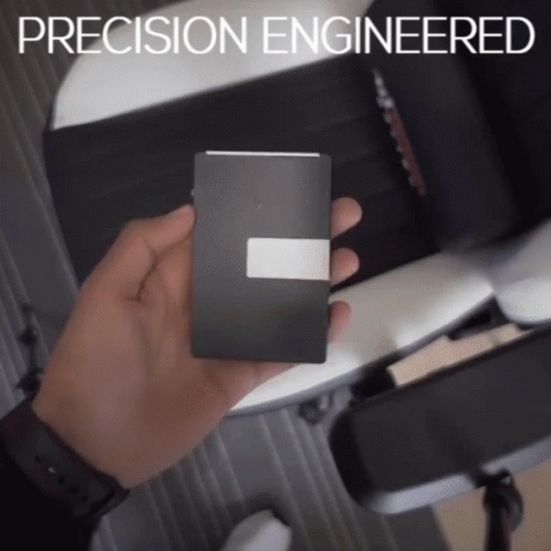 a person holds a cell phone that reads precision engineering