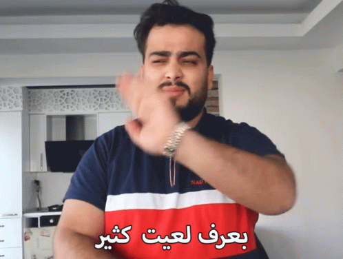 a man wearing an arabic shirt making gestures