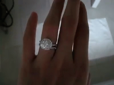 the woman is wearing an elegant white diamond ring
