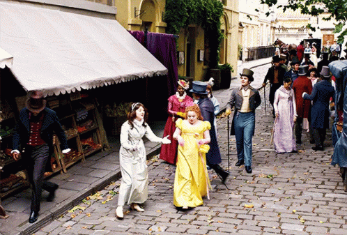 people dressed in costume walking down the street
