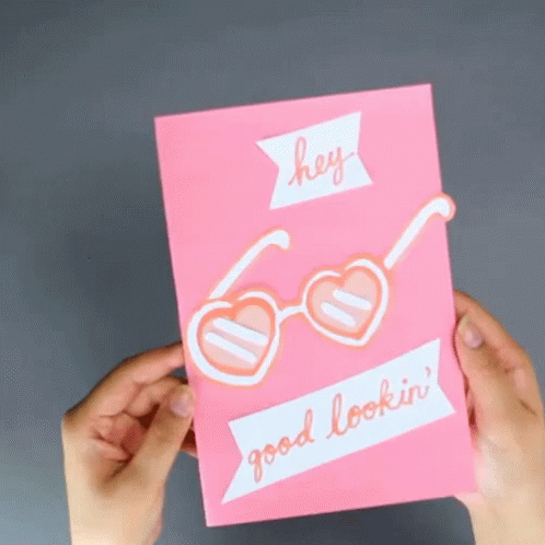 hands holding an empty purple card with heart - shaped glasses