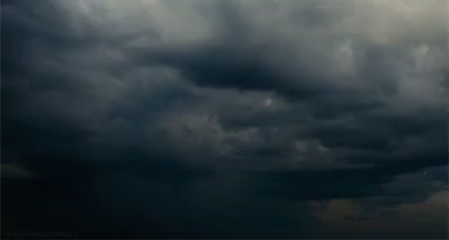 storm clouds and an airplane in flight