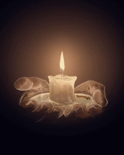 an ice candle lit by a clear candle