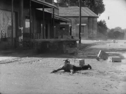 a black and white po of an old man lying on the street