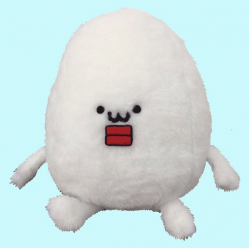 a white stuffed animal with one eye open and a blue patch on it's chest