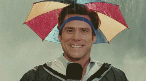 a young man is smiling while wearing an umbrella hat