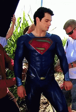 the young man has his superman suit on