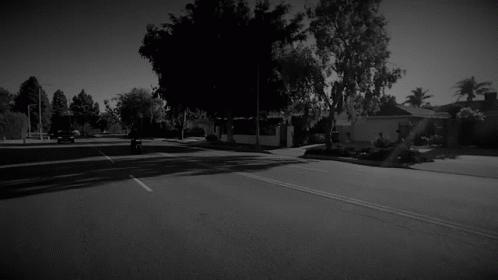 there is a black and white image of an empty street
