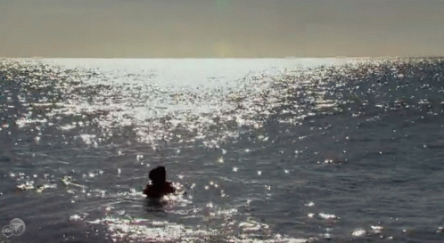 a lone man is floating in the ocean