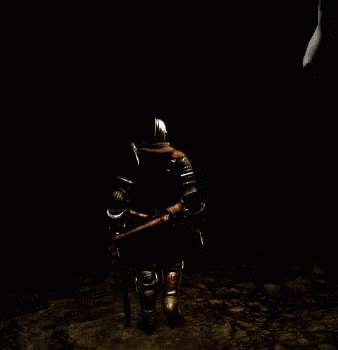 a man in armor sits in the dark alone