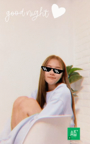a girl wearing shades and holding a laptop