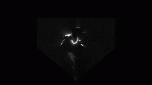 a black and white pograph of a man in the dark