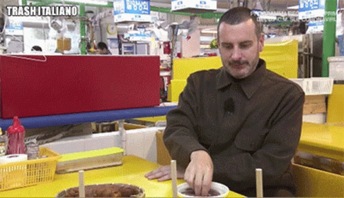 man standing by table in an indoor retail store
