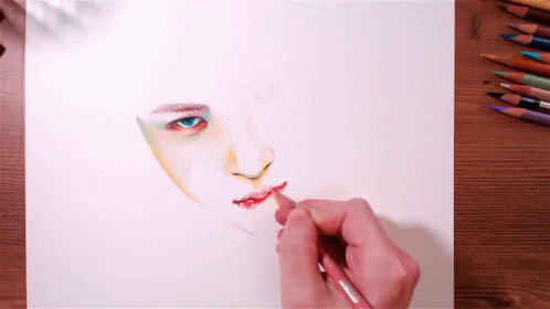 someone is drawing soing on paper with colored pencils