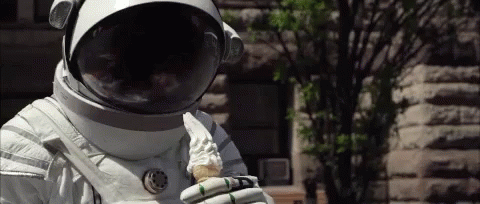 a person wearing an astronaut suit holding a phone