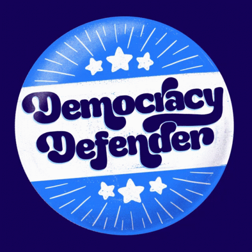a sticker is advertising democracy against the camera