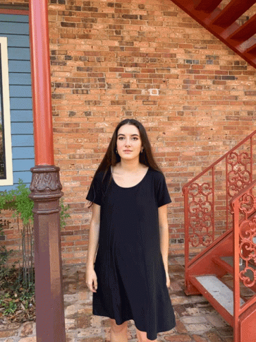 an evil looking girl standing in front of some steps